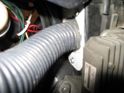 My air intake hose sucks from the original Honda airbox.  I build an attachment plate for the hose out of aluminum house eve fascia.