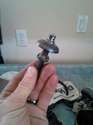 My revised clutch-pusher thingy.  I had to make this much longer than the original, and I made it to stick into the inner race of the bearing in the middle of the clutch disengagement plate so that everything would stay centered. Hopefully the little bearing doesn't wear out too fast.  The curved cup is from a mcpherson strut.  I just used it because it fit nicely around the rod I extended the clutch-pusher with, but its outer diameter was the same as the inner race of the little bearing.