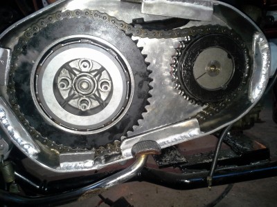 the big sprocket is on the left.  The out-of-center isn't enough to be visible without spinning the piece